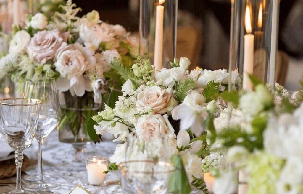 Classic florals showcased on reception table at a wedding. 